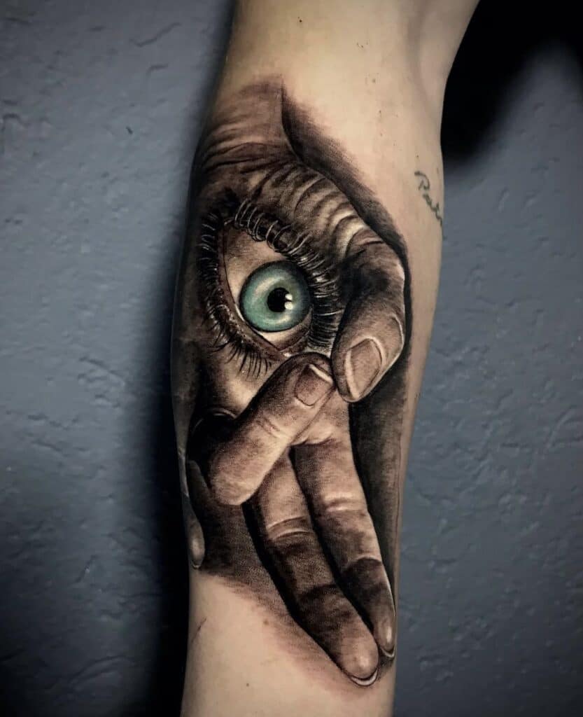 hand and eye tattoo